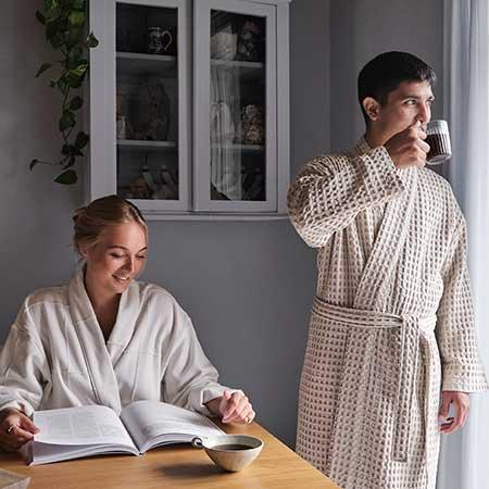 man and woman wearing organic cotton dressing gowns