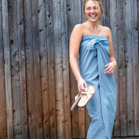 woman smiling with her wellness towel