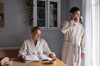 man and woman wearing big waffle bathrobe