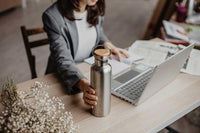 woman using a bambaw insulated water bottle