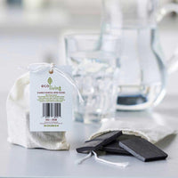 bamboo charcoal water filter beside cotton pouch
