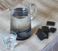 bamboo charcoal water filter in glass jug of water