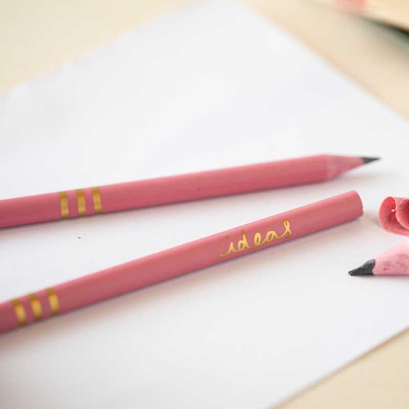 recycled pink pencils on a piece of paper