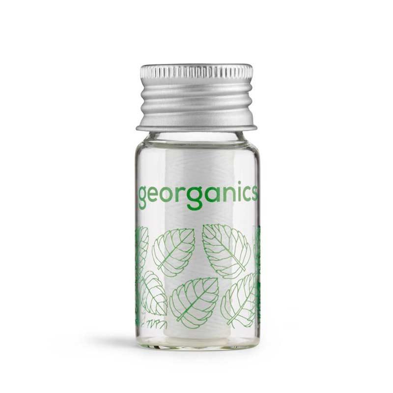 natural floss in a glass dispenser