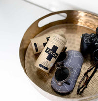 plastic free plasters on a golden tray with sunglasses