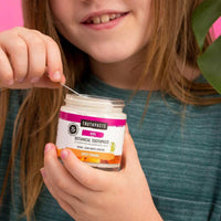 child holding botanical toothpaste sweet orange