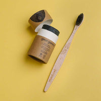 charcoal toothsoap next to bamboo toothbrush