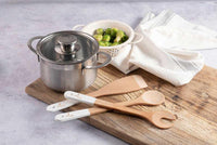 wooden kitchen servers set on kitchen side with pots and pans
