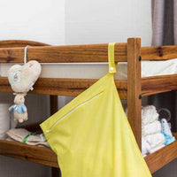 hanging nappy bag hanging on the side of a bed