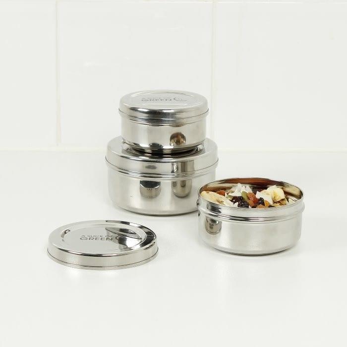 stainless steel food containers arranged on a table