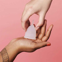 women holding an organicup menstrual cup