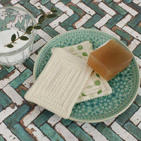 organic cotton scrub unsponge on a soap dish