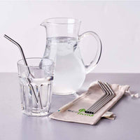 stainless steel straws next to jug of water