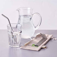 stainless steel straws next to jug of water