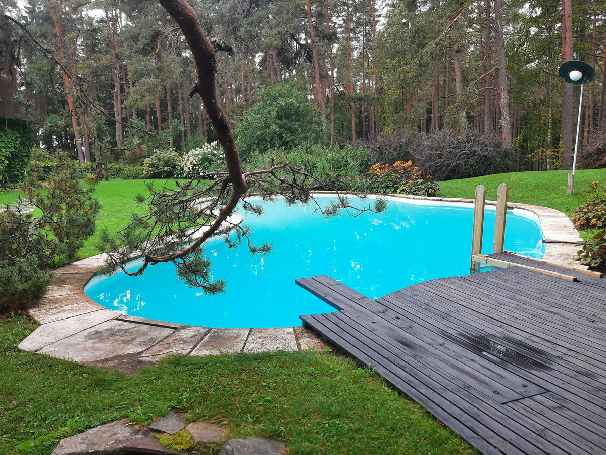 Garden renovation with wooden decking, natural stone landscaping and green planting