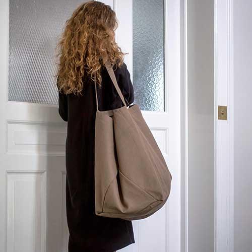 woman holding sustainable tote bag