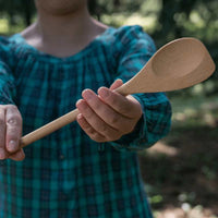 woman holding a bamboo spoontula