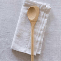 bamboo spoontula beside tea towel