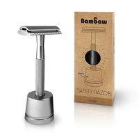 silver safety razor on a stand