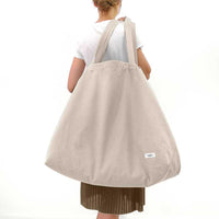 large organic bag over womans shoulder