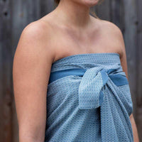 woman wearing a blue wellness towel