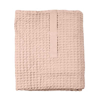 pink waffle bath towel folded up