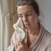 woman using organic muslin cloths