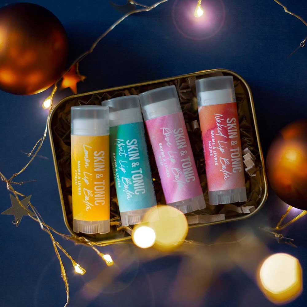 merry and bright lip balm gift set next to christmas lights