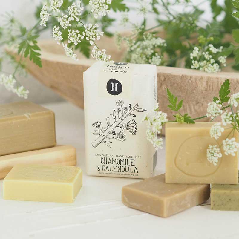 chamomile olive oil soap bar next to flowers
