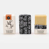 black beer and olive oil soap bar in paper packaging
