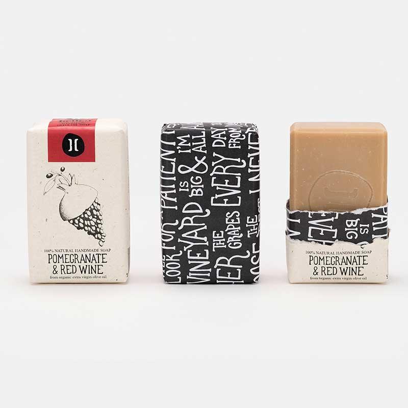 olive oil and pomegranate soap bar in paper packaging