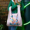 woman holding a summer afternoon reusable shopping bag