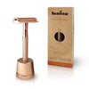 rose gold safety razor on a stand