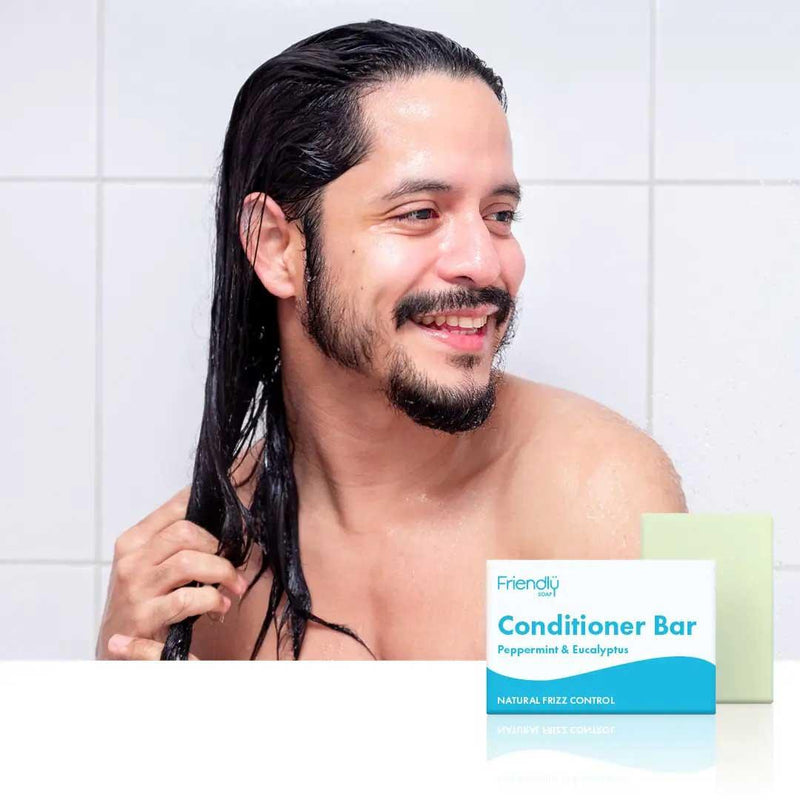 man using conditioner bar in shower