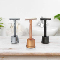 3 metal safety razors on stands