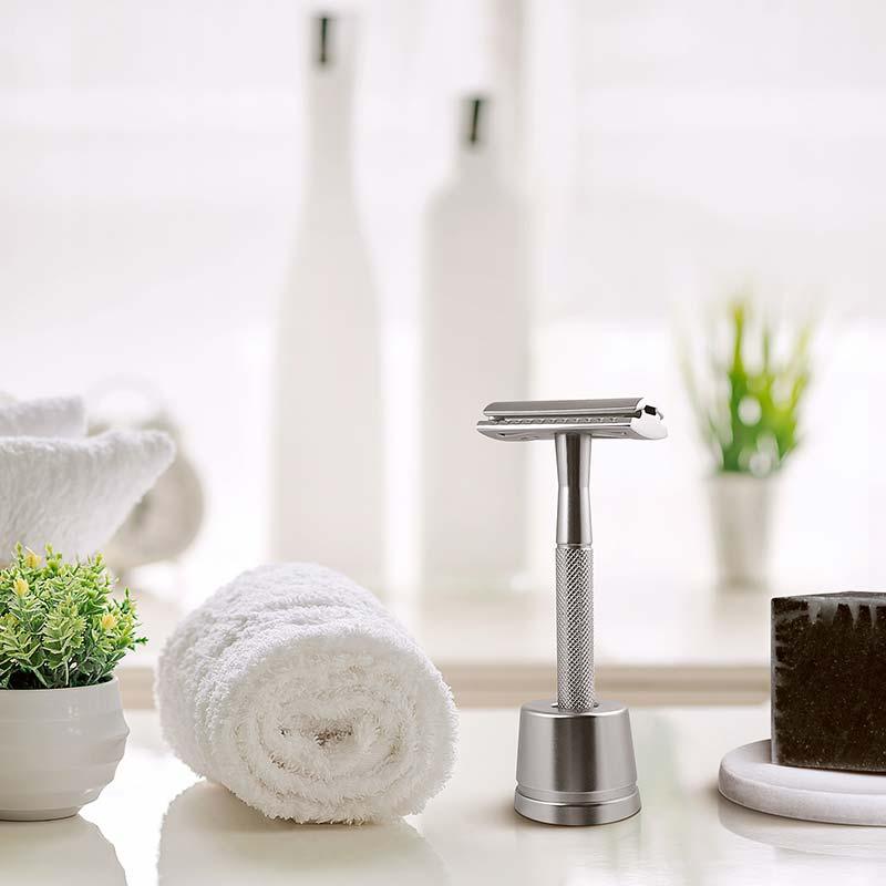 silver safety razor next to a towel