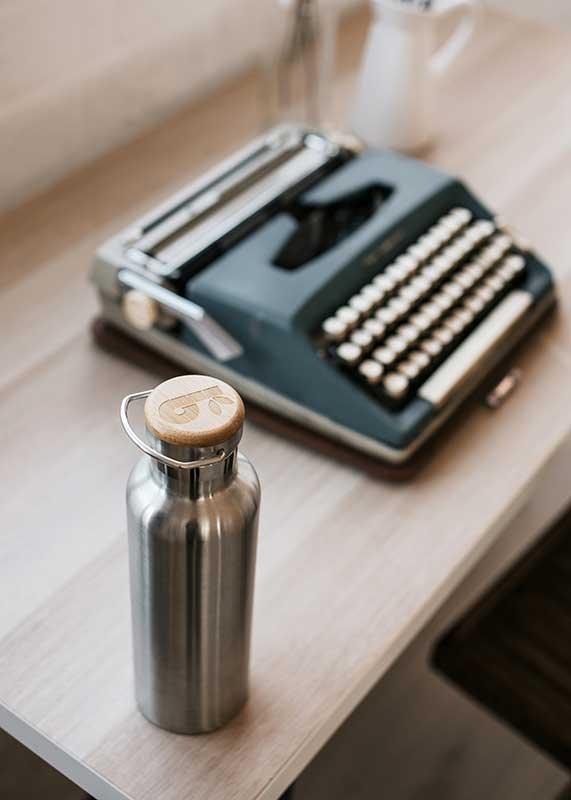 bambaw insulated water bottle next to typewriter