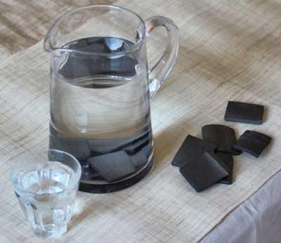 bamboo charcoal water filter in glass jug of water