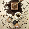coffee face scrub with coffee beans scattered around