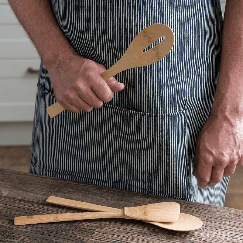 chef holding a bamboo spatula