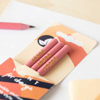 recycled pink pencils laying on table