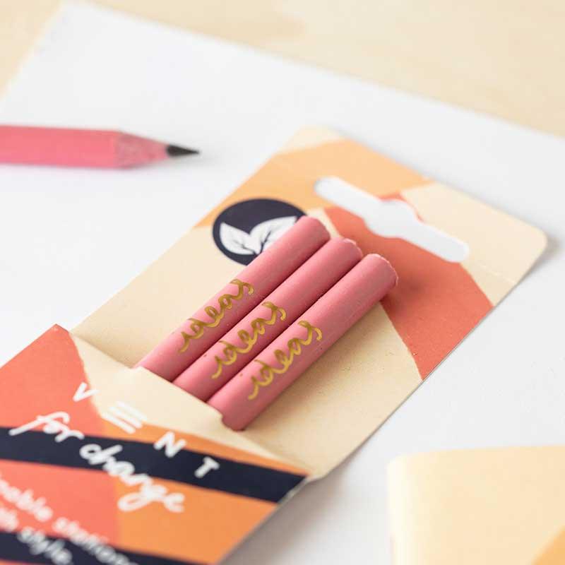recycled pink pencils laying on table