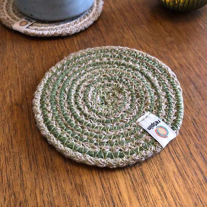 green jute coaster on a table top