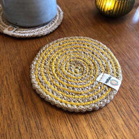 yellow juste coaster on a table
