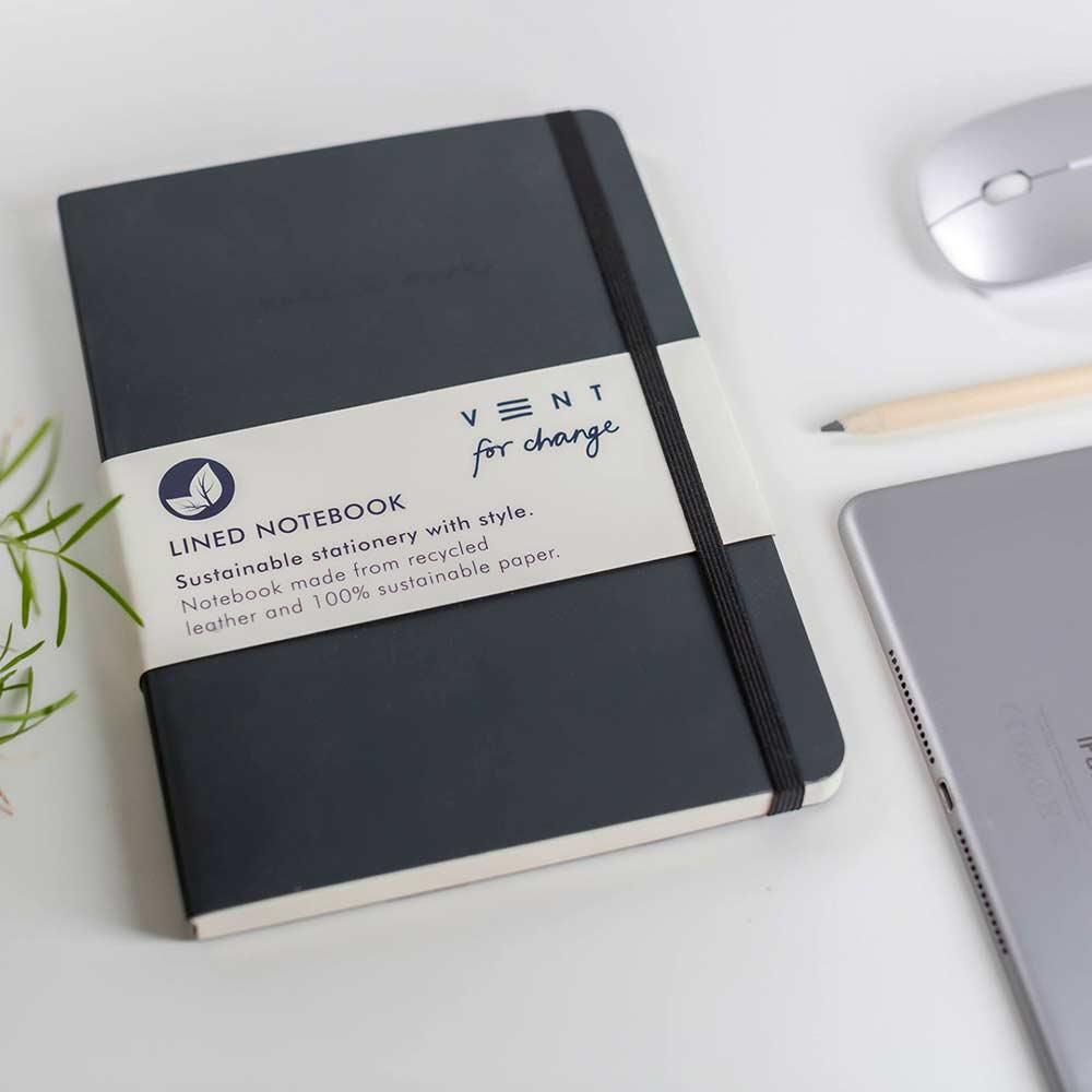 charcoal grey recycled leather notebook laying on desk