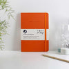orange recycled leather notebook standing on desk