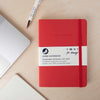 red recycled leather notebook on desk