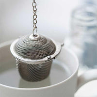 loose tea basket hanging in mug of water