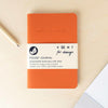 recycled leather pocket journal flat on desk