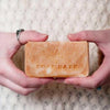woman holding natural handmade soap in hands
